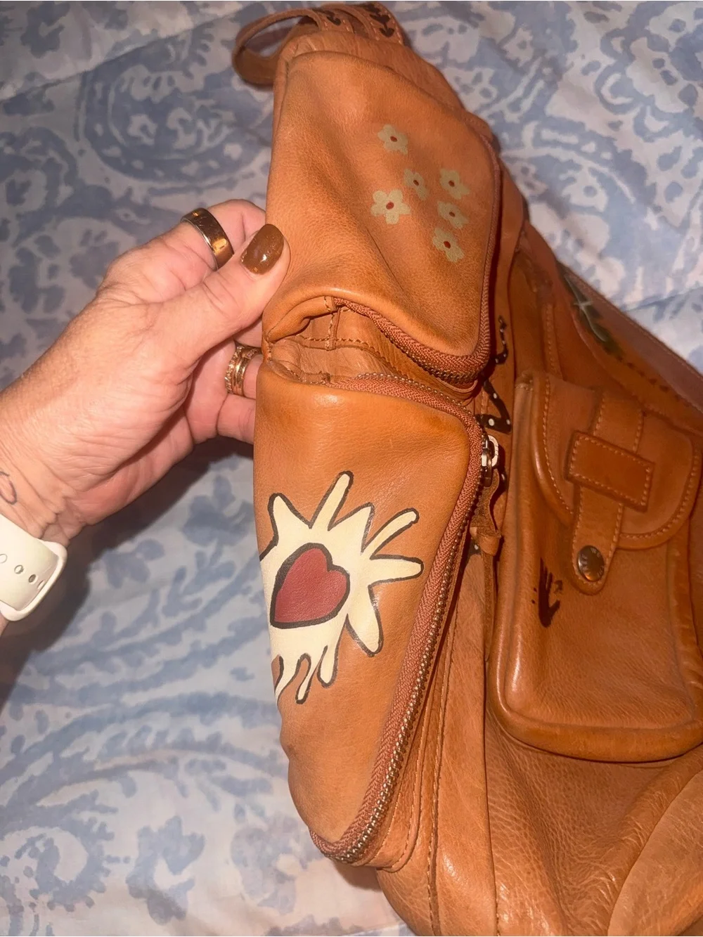 Compact Brown Leather Sling Backpack with Decorative Accents